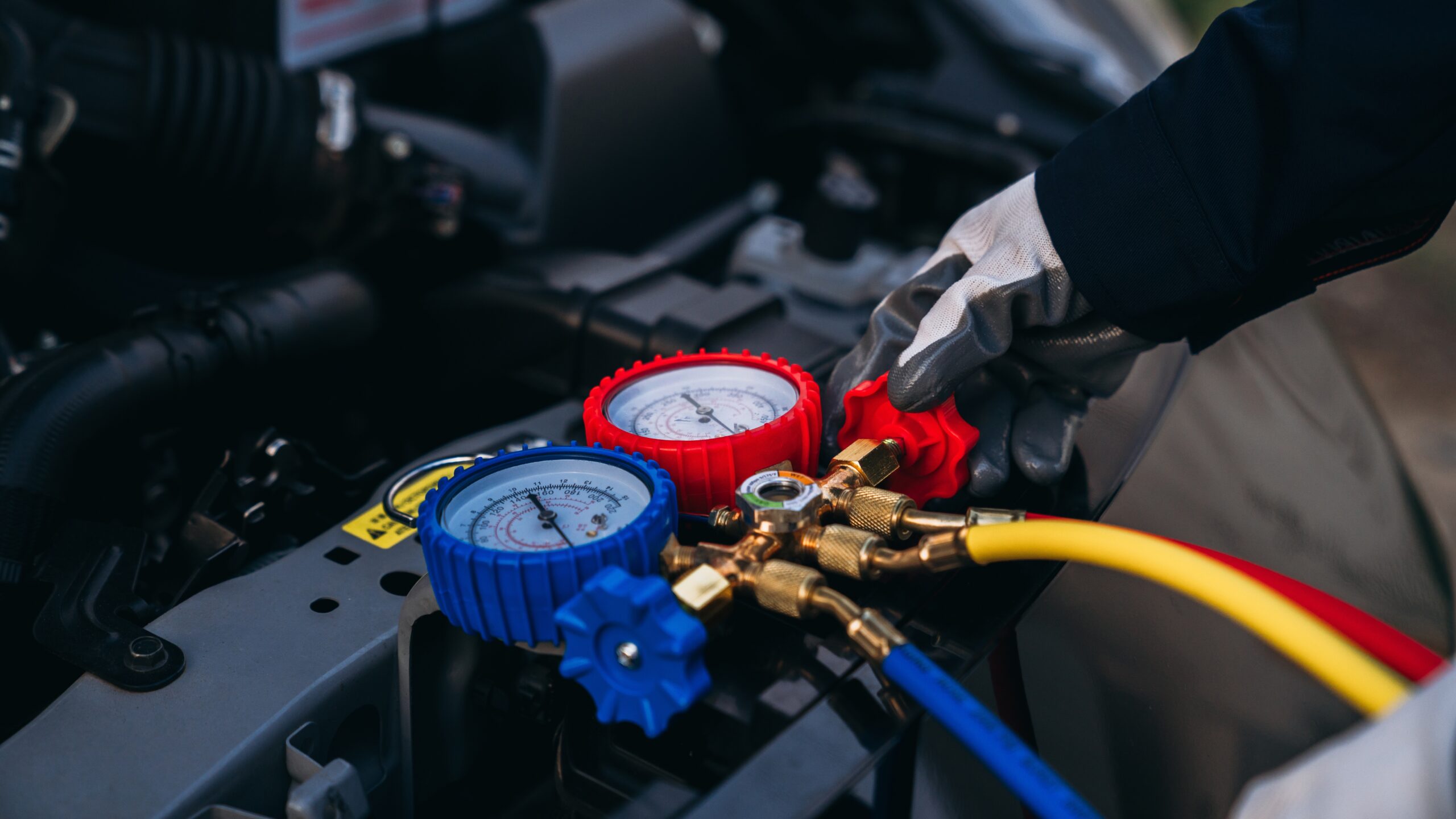 Close up photo of a car undergoing a air conditioning service.